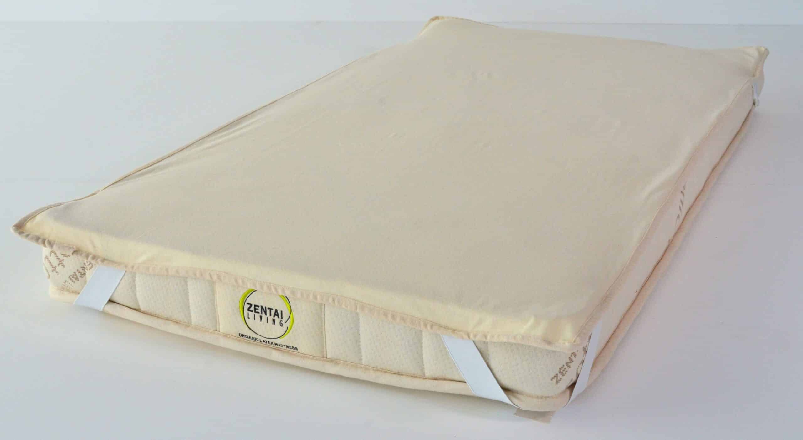 Cot mattress with fitted waterproof protector, sold separately